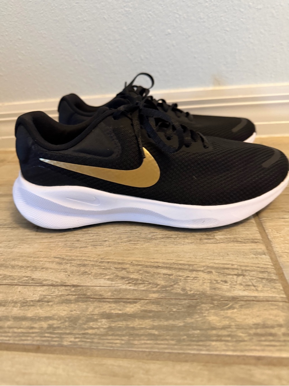 Nike Women's Black Running Sneakers with Gold Swoosh